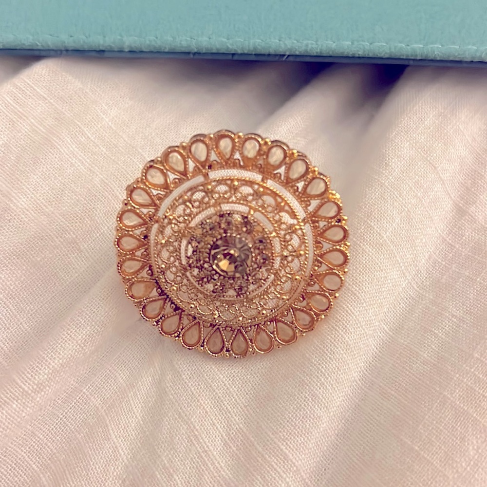 Golden fashion ring with crystal in the middle